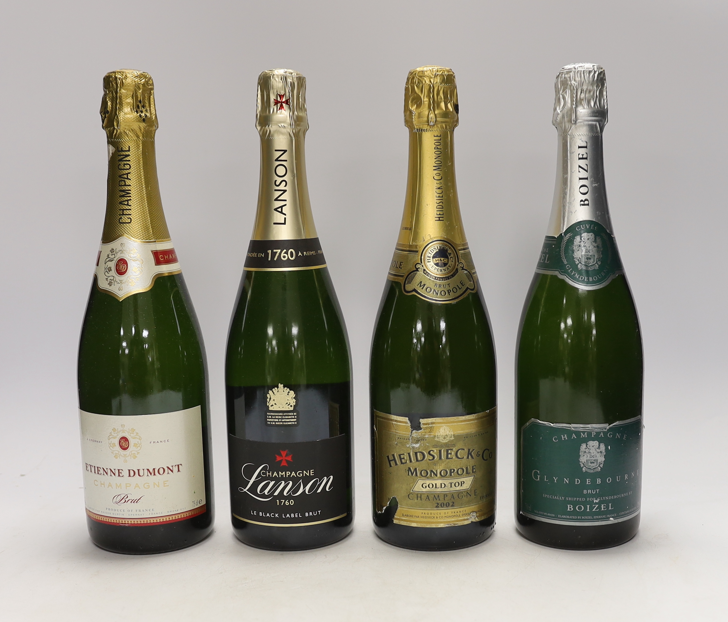 Four bottles of champagne; a Heidsieck & Co. 2002, a Boizel for Glyndebourne, a Lanson Black Label and an Etienne Dumont